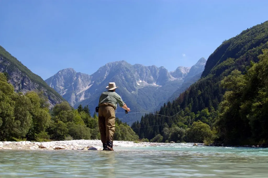 A man fishing on the Soča River